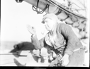 Image of Bartlett aboard with pipe, gesturing